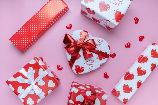 Open kit box with twelve white card bases, frosted green and silver patterned panels, gold foil sentiment strips, a spool of red twine and stacked kraft envelopes